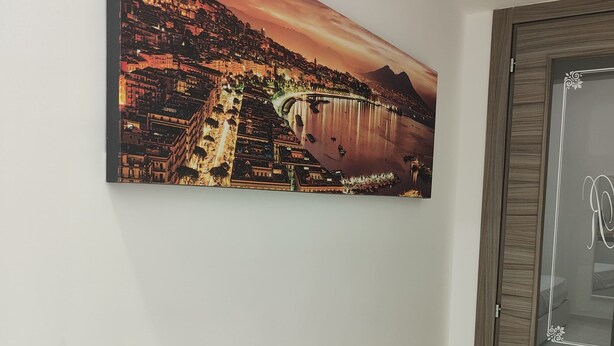 A framed cityscape painting on a wall. - Relax and comfort in the center of Naples (Napoli)