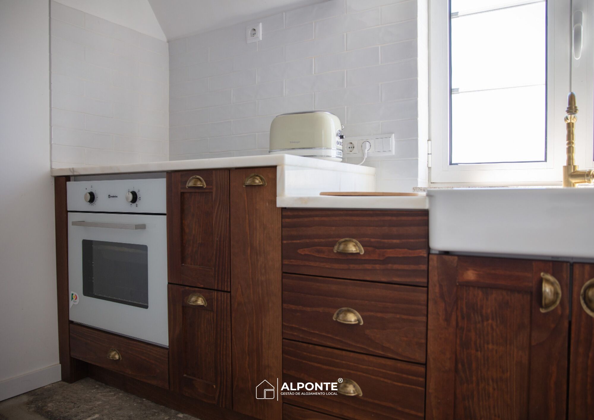 A kitchen with a white oven, wooden cabinets, and a white countertop.