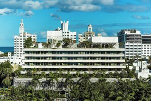 A multi-story hotel with a modern architectural design, featuring balconies and a view of the ocean. - UNFRAMED, Autograph Collection (Miami Beach)