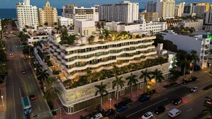 A multi-story hotel with a modern design, featuring balconies and a landscaped rooftop. - UNFRAMED, Autograph Collection (Miami Beach)