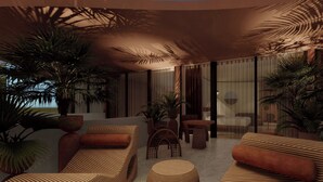 A modern lounge area with sofas, a round table, and potted plants. - UNFRAMED, Autograph Collection (Miami Beach)