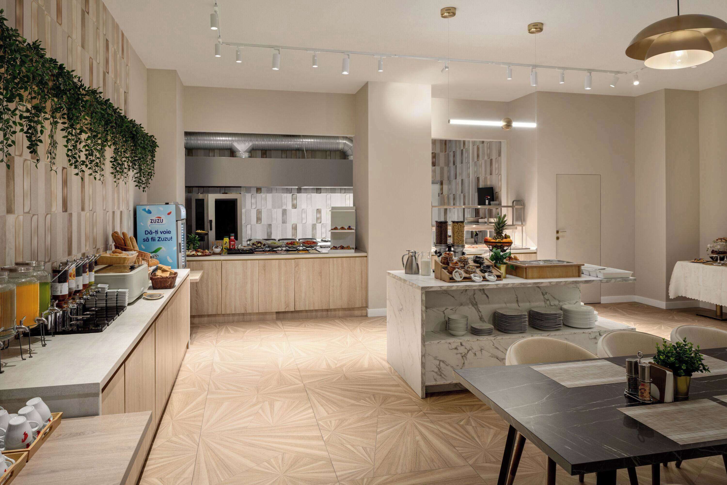 A modern kitchen with a marble island, wooden cabinets, and a breakfast bar.