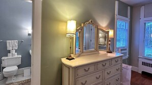 A bathroom with a vanity, mirror, and a toilet.