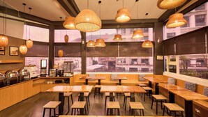 A restaurant with wooden tables and benches, large windows, and woven pendant lights. - Tenlien onsen Hot Spring Hotel (Jiaoxi)
