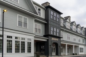 A multi-story building with a prominent 'REGEN' sign, large windows, and a covered outdoor seating area. - Brookmere Saratoga, a Tribute Portfolio Hotel  (Saratoga Springs)