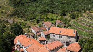 A hillside village with traditional stone houses and terraced fields.