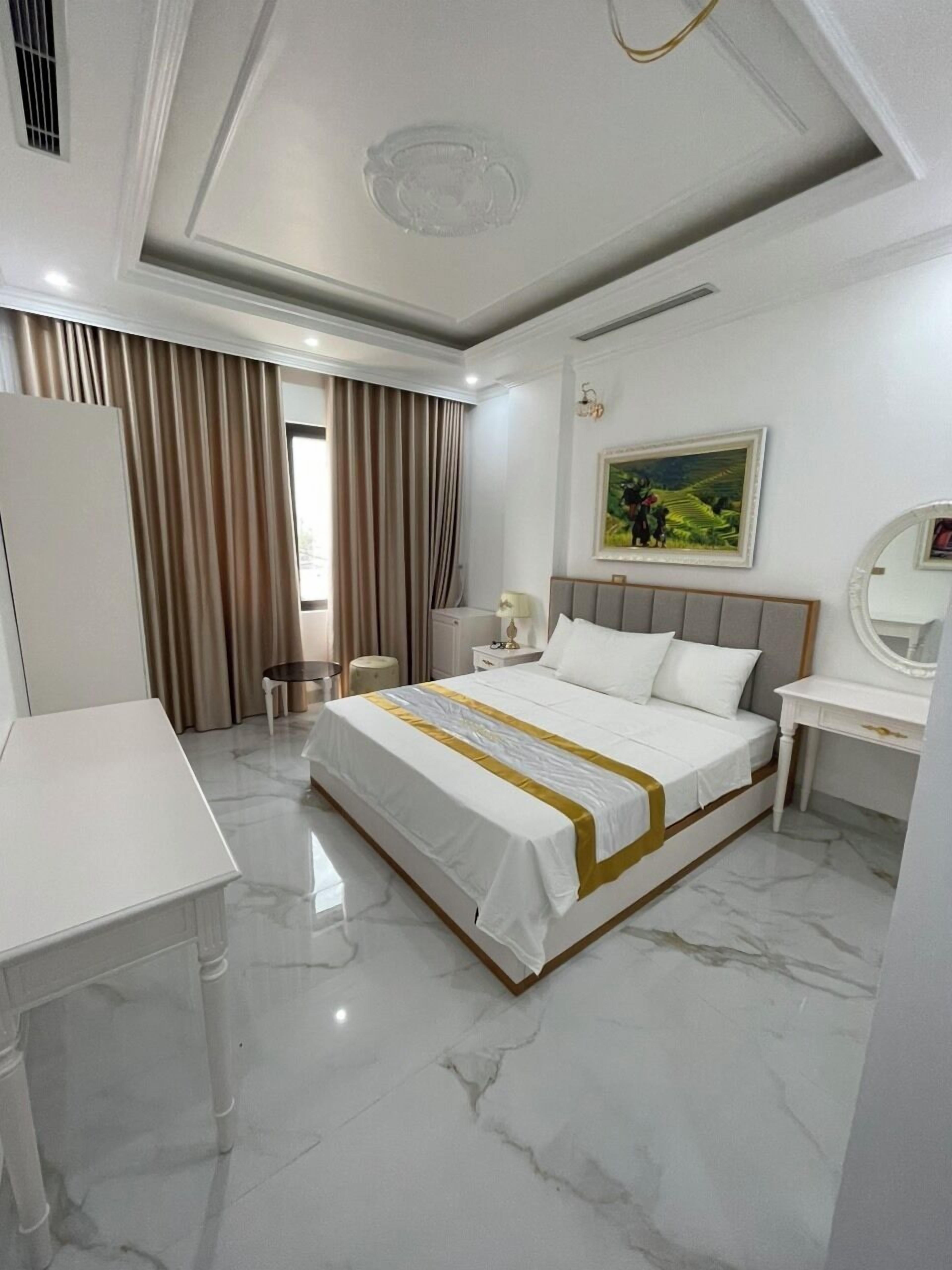 Una habitación de hotel moderna con una cama grande, una mesita de noche, un escritorio y una silla.
