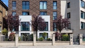 Un edificio moderno de varios pisos con fachada de ladrillo y ventanas grandes.