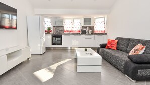 A modern apartment with a living room, kitchen, and dining area. - Apartment Zubčić by Interhome (Sv. Filip i Jakov)