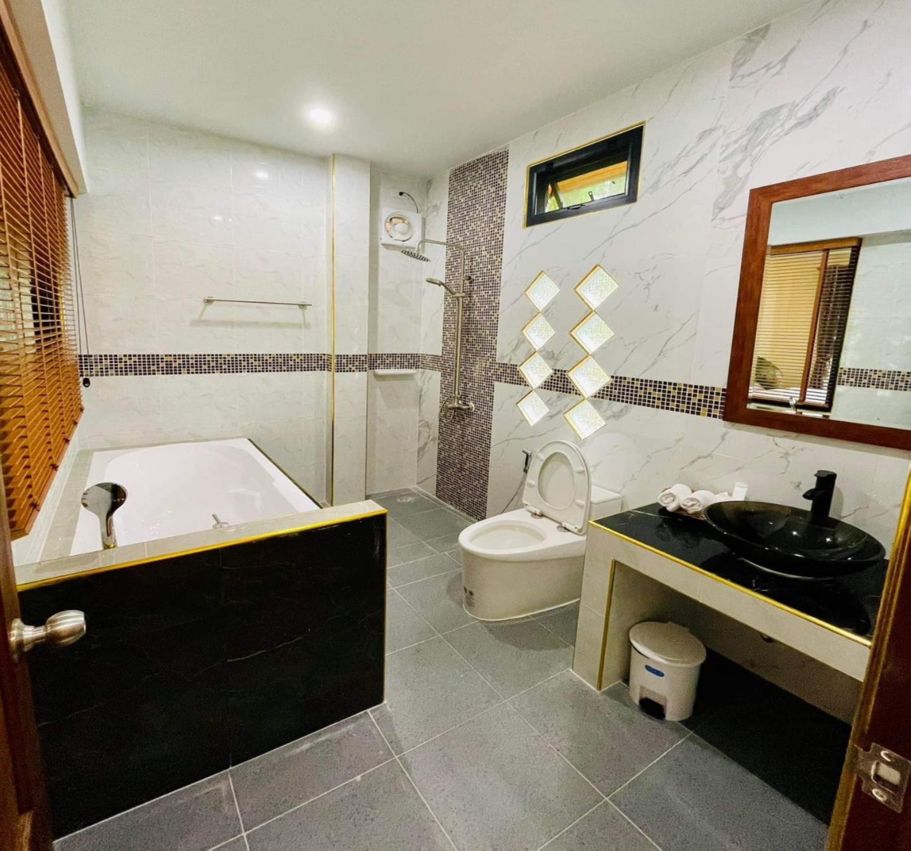 A bathroom with a bathtub, toilet, and sink.
