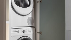A compact, wall-mounted washer and dryer unit with a control panel and a small storage compartment. - Qult·co - Legends of the Fall (București)