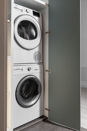 A compact, wall-mounted washer and dryer unit with a control panel and a small storage compartment. - Qult·co - Legends of the Fall (București)