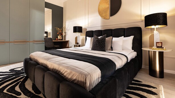A modern bedroom with a large bed, bedside tables, a desk, and a wardrobe. - Qult·co - Legends of the Fall (București)