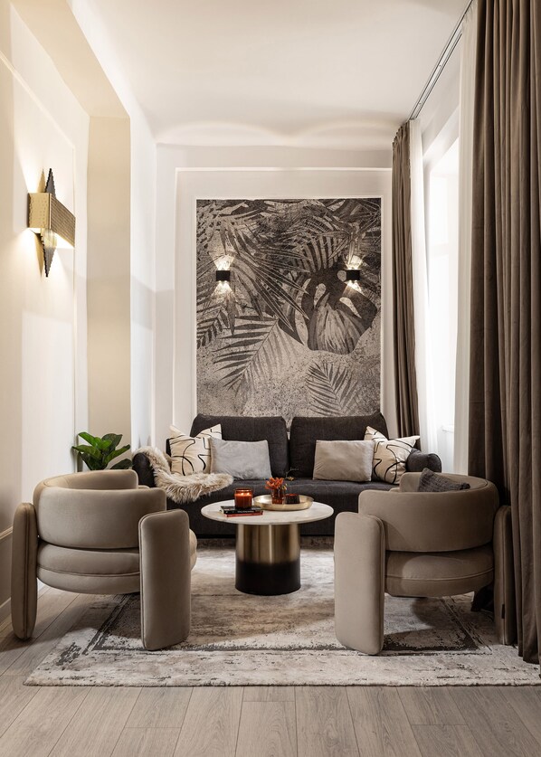A modern living room with a large abstract painting, a sofa set, and a coffee table.