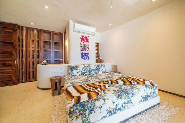 A bedroom with a bed, bedside table, and a wooden wardrobe.