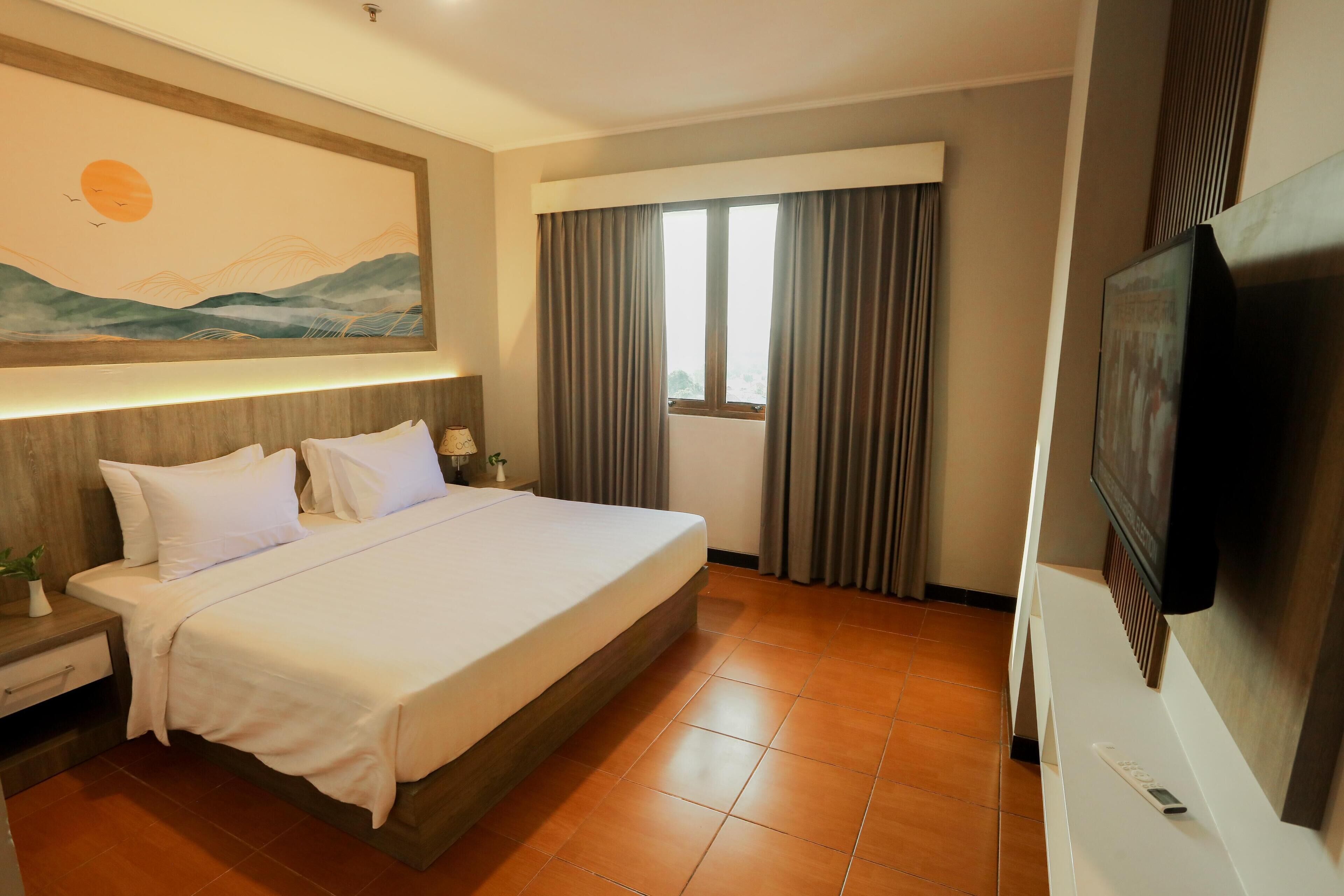 A hotel room with a large bed, a TV, a painting on the wall, and a window with curtains.