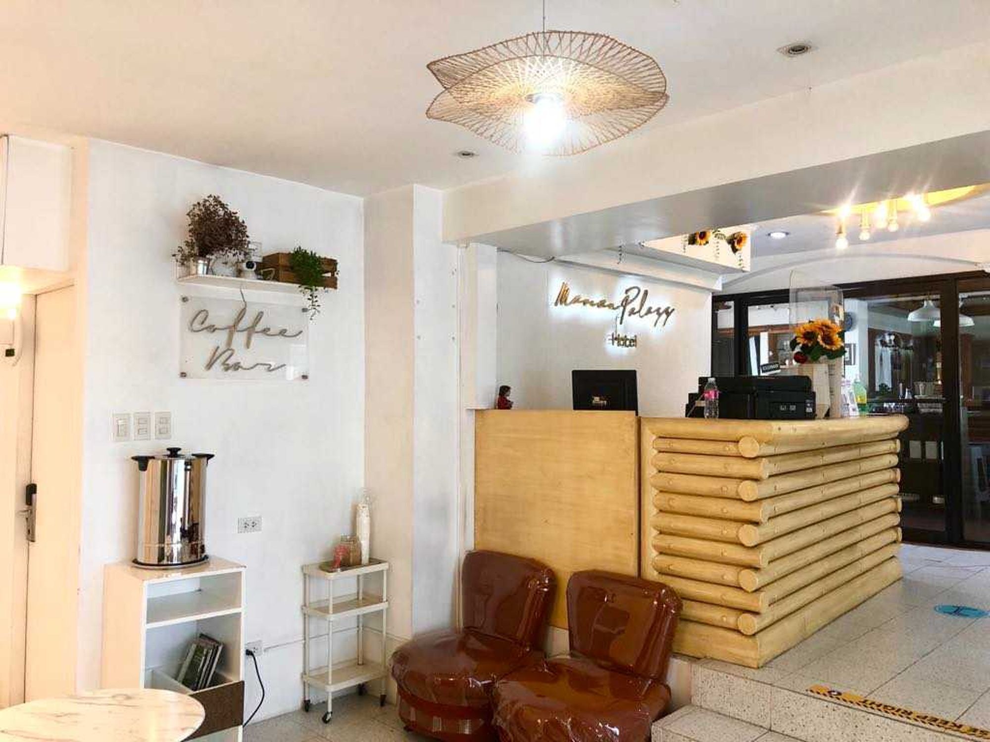 A reception area with a coffee bar sign, a reception desk, and a seating area with chairs.