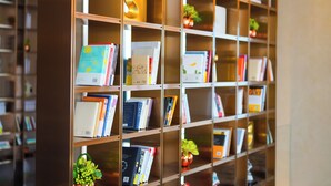 A bookshelf with various books and decorative items.