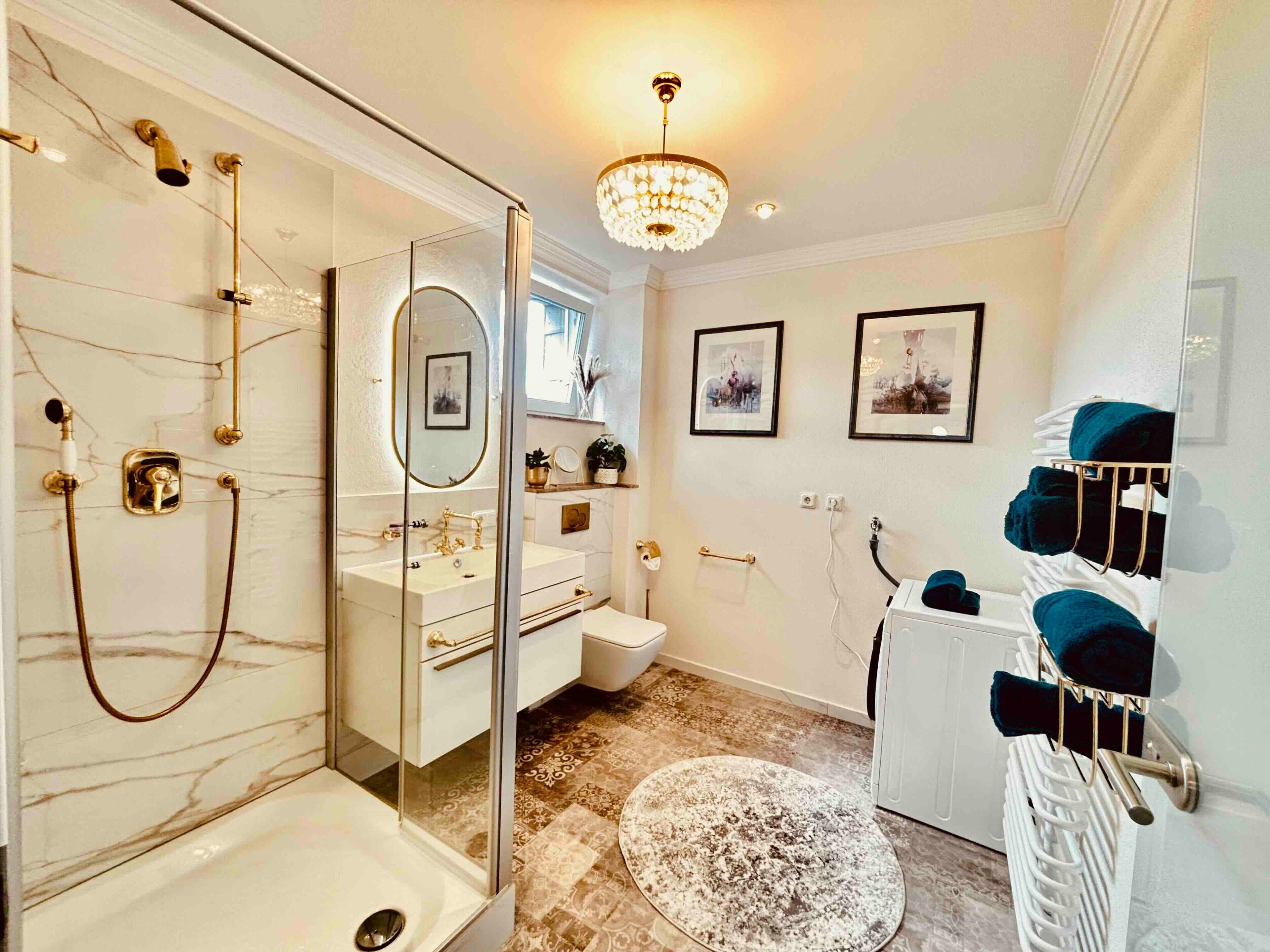 A modern bathroom with a glass-enclosed shower, a vanity with a mirror, a toilet, and a radiator with towels.