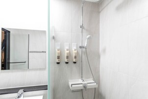 Habitación estándar doble, no fumadores, baño privado | Baño | Ducha, artículos de higiene personal de diseño y secador de pelo