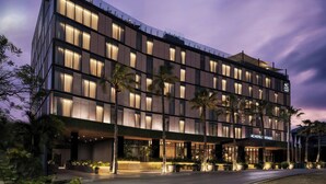 A modern hotel with a flat roof, multiple floors, and a well-lit facade. - AC Hotel Santiago de los Caballeros (Santiago de los Caballeros)