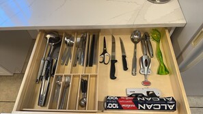Kitchen essentials at your fingertips, including utensils, a bottle opener, and can opener.