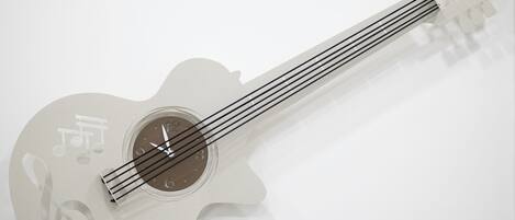A guitar with a clock face on the body.