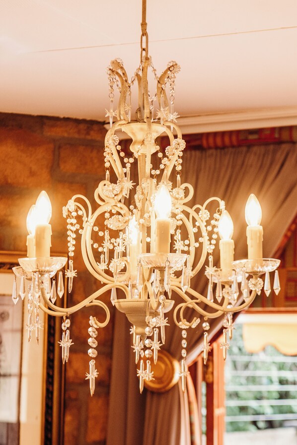 A chandelier with multiple candles and decorative elements.