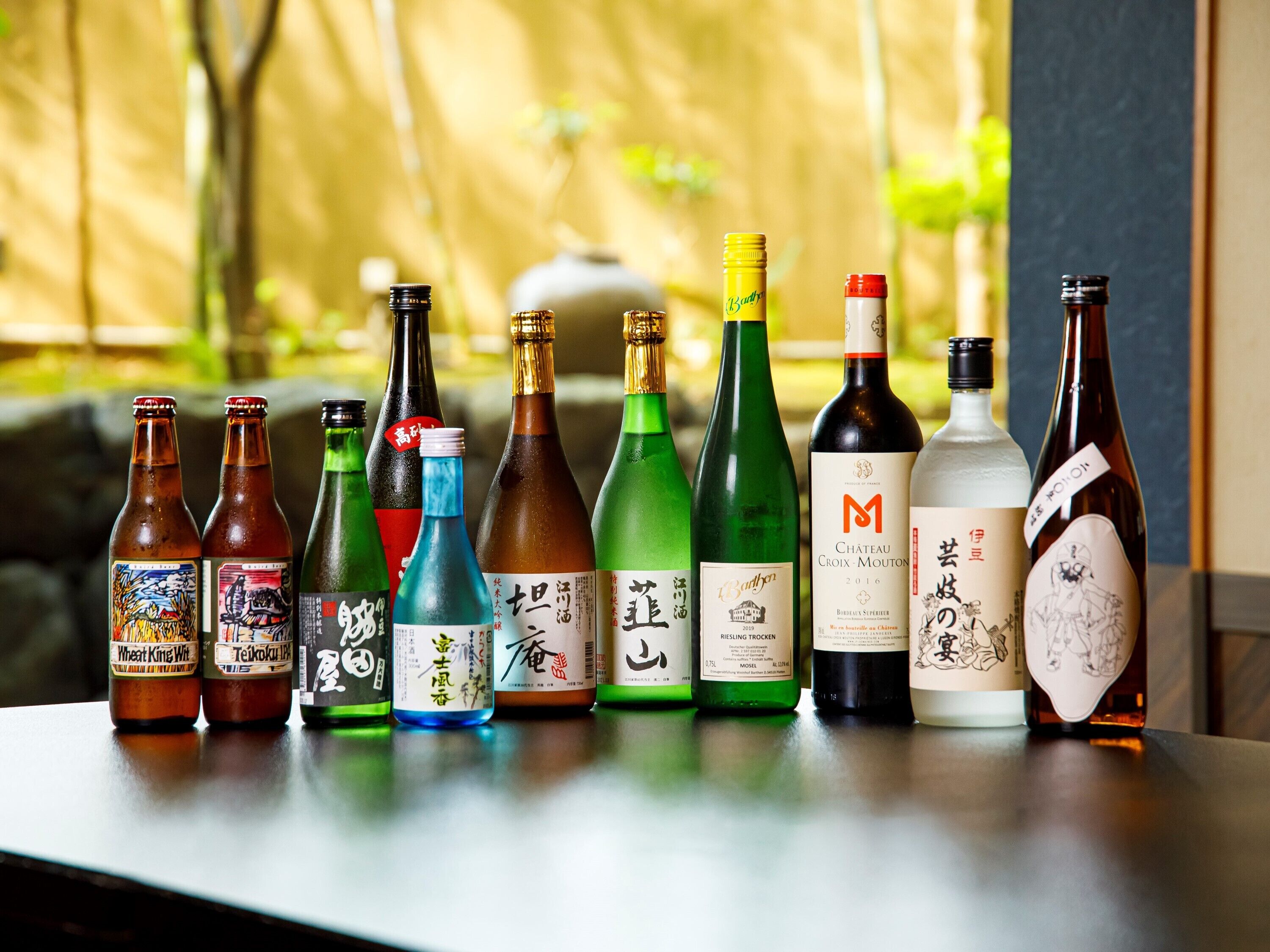 A variety of bottles of beverages arranged on a table.