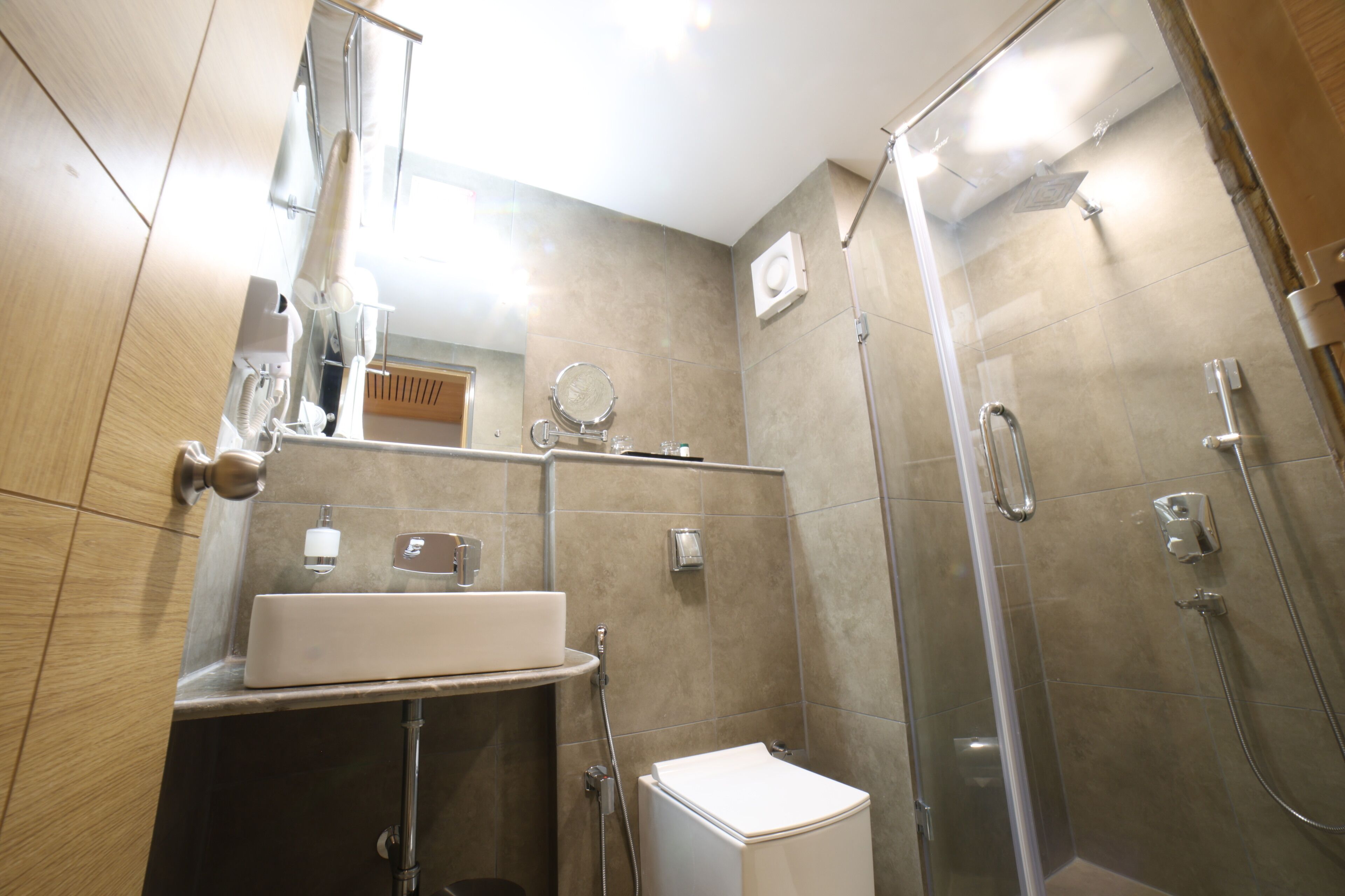 A modern bathroom with a toilet, sink, and shower.