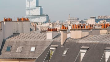 A cityscape with a mix of modern and traditional architecture, including a prominent modern building in the background.