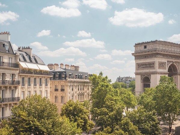 A historic building with classical architecture, including a prominent archway and detailed stone carvings. - Miss Fuller (Paris)