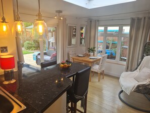 Enjoy a spacious living area with a kitchen, dining space, and comfortable seating area offering views of the outdoors.