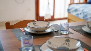 A dining table with a bowl and a glass on it. - Corallo Blu in San Teodoro (San Teodoro)