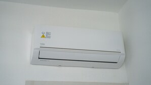 A wall-mounted air conditioner with a warning label and the brand name 'beko'. - Das Halte Haus - Room 302 (Olbia)