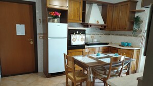 Comfort Triple Room, Courtyard View | Shared kitchen | Espresso maker, coffee/tea maker, full-size fridge, microwave - Tra Pirandello e Leopardi B&B (Naples)