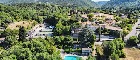 Un quartier résidentiel avec des maisons, une piscine et de nombreux espaces verts.