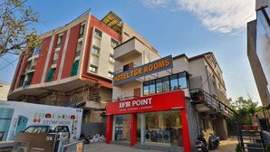 A hotel with a sign for 'HOTEL TGR ROOMS' and 'IFB POINT' offering living, kitchen, and laundry services. - Hotel TGR Rooms (Palanpur)