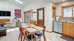 A modern kitchen with a dining area, wooden cabinets, a built-in oven, and a large window. - Alameda Studio w/ Patio: 3 Mi to Oakland Coliseum! (Alameda)