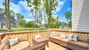 A wooden deck with wicker furniture, including a sofa and chairs, and a small table. - Hike, Sip & Ski: Spacious Poconos Home (Kunkletown)