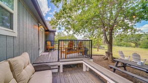 A wooden deck with a sofa, chairs, and a picnic table. - On-site River Access: Medina Vacation Rental (Medina)