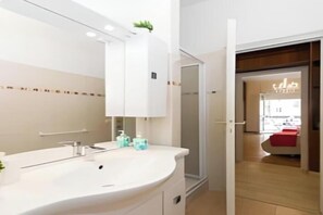 A modern bathroom with a large sink, mirror, and cabinets. - Modern Elegance in the Heart of Rome: Spacious 250 m² Apartment
 (Roma)