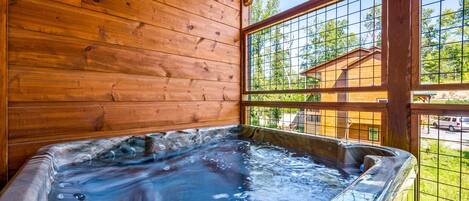A wooden cabin with a hot tub.