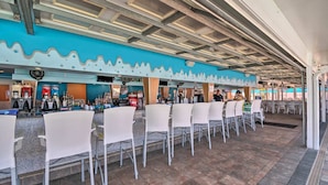 A bar area with white chairs and a counter. - Sarasota Resort Home Pool Golf Beach Siesta Key St. Armands Downtown Pickleball (Sarasota)