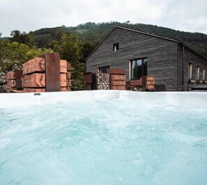 Escape to a serene retreat surrounded by nature, with a tranquil hot spring and sauna nearby.