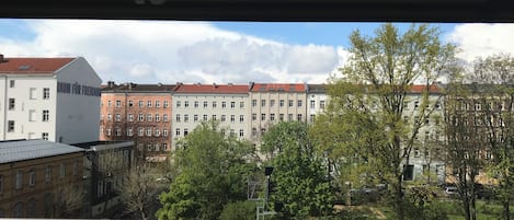 A view of a row of multi-story buildings with a mix of architectural styles, including a building with a sign that reads "RAUM FÜR FREIHOF."