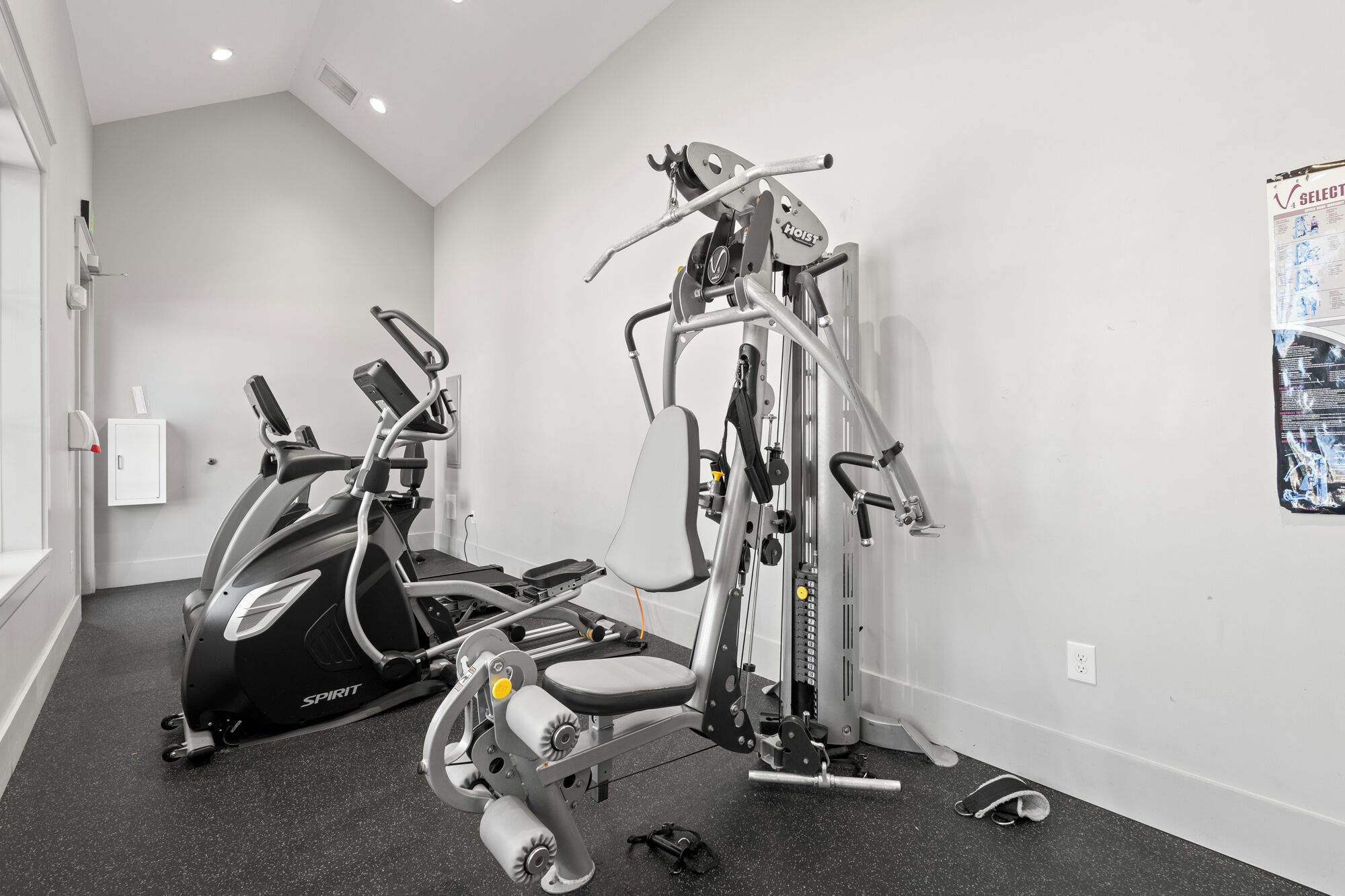 A gym with cardio machines and weight training equipment.