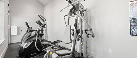 A gym with cardio machines and weight training equipment.