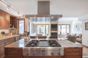 Enjoy cooking in the kitchen with a gas stove and central island, then relax in the adjacent living area with a fireplace and comfortable seating.