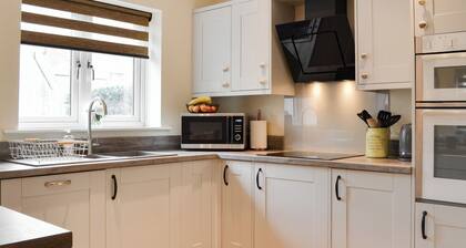 We love the open plan living area with wood burner.